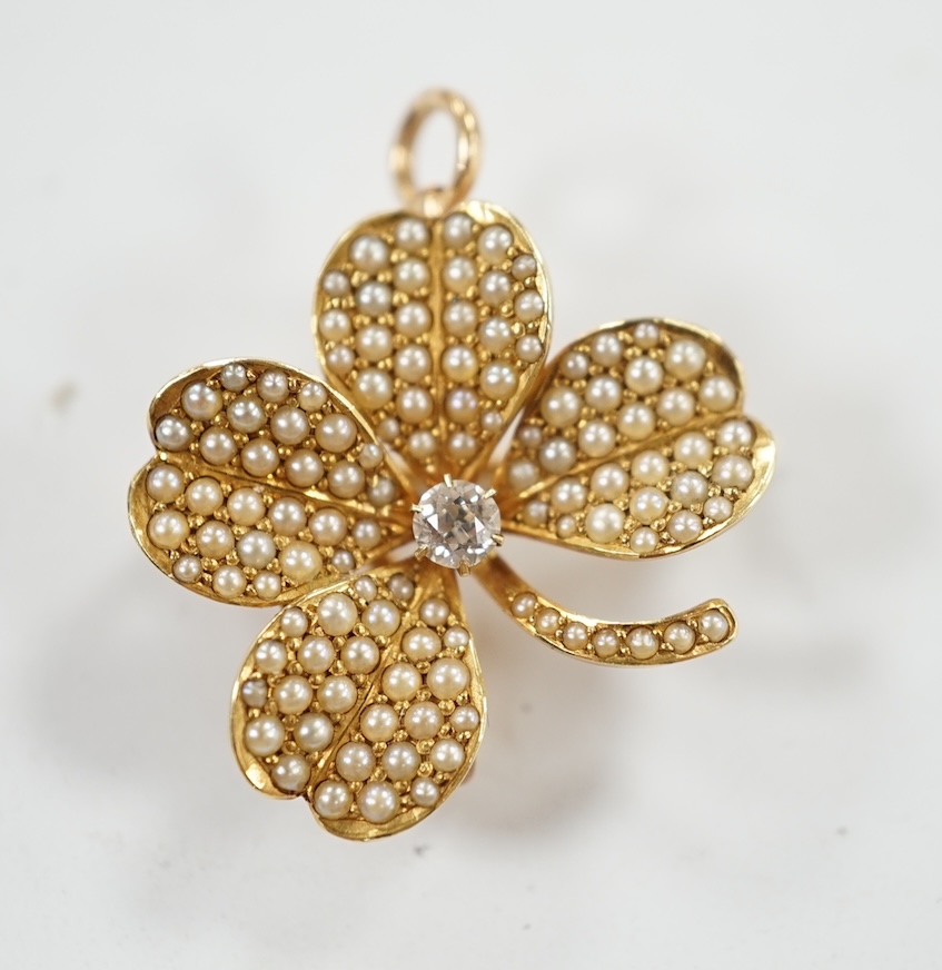 A 14k diamond and seed pearl set clover pendant brooch, width 21mm, gross weight 4.8 grams. Condition - fair to good